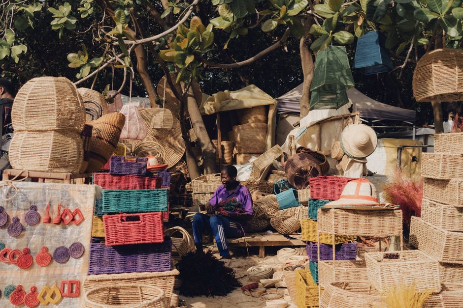 Vibrant street market in South Africa with local vendors and shoppers, illustrating daily costs