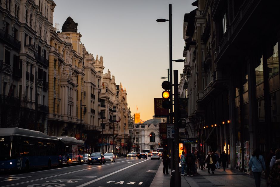 Vibrant street scene in a Spanish city with people enjoying outdoor cafes