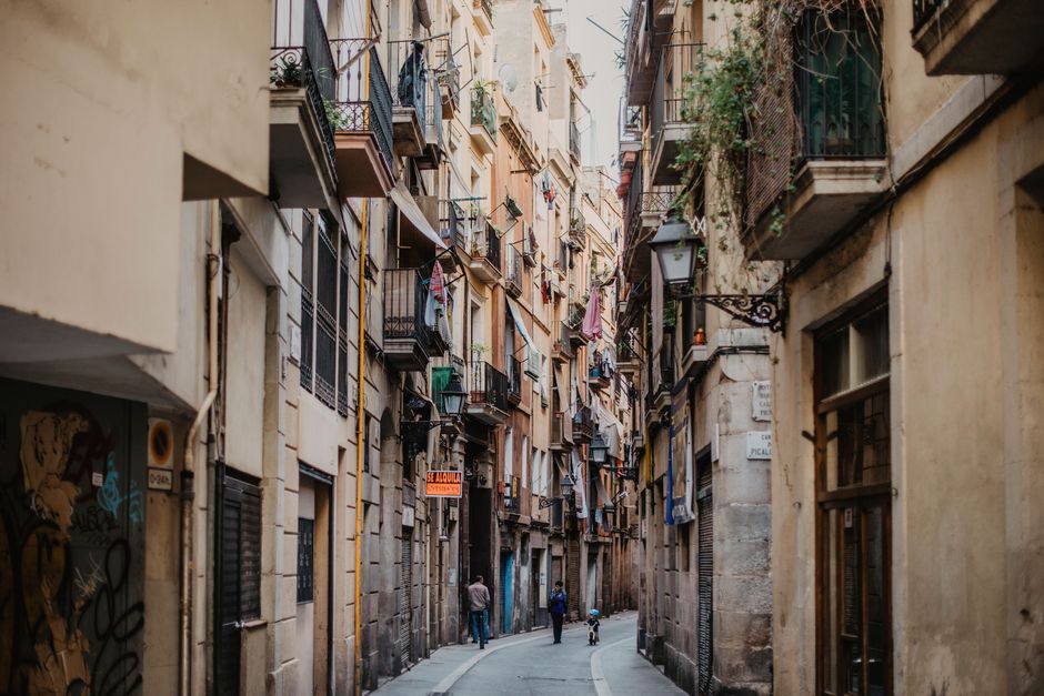 Travelers enjoying a vibrant street in Spain on a budget