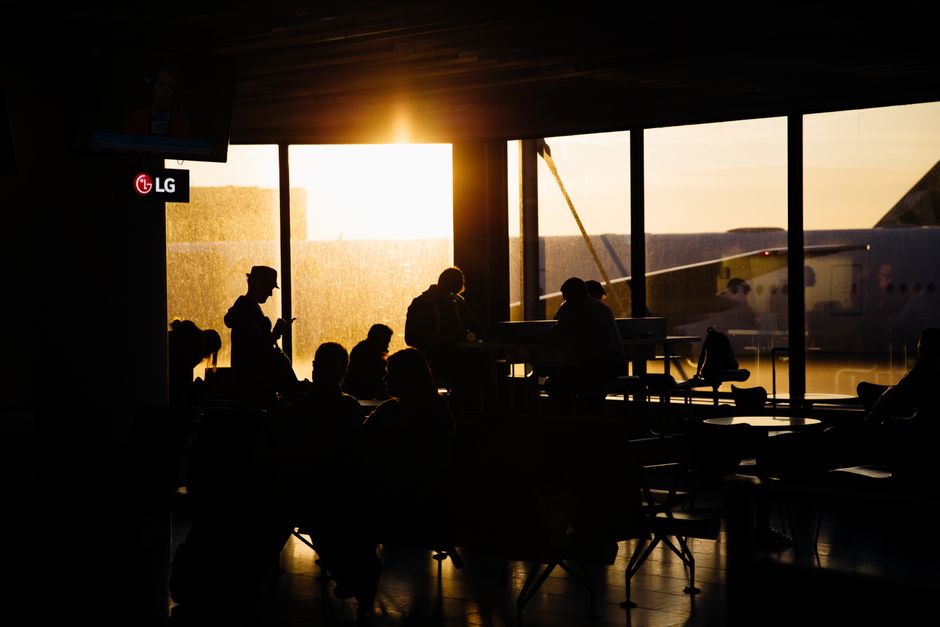 Passenger looking at a flight delay screen at a Spanish airport terminal