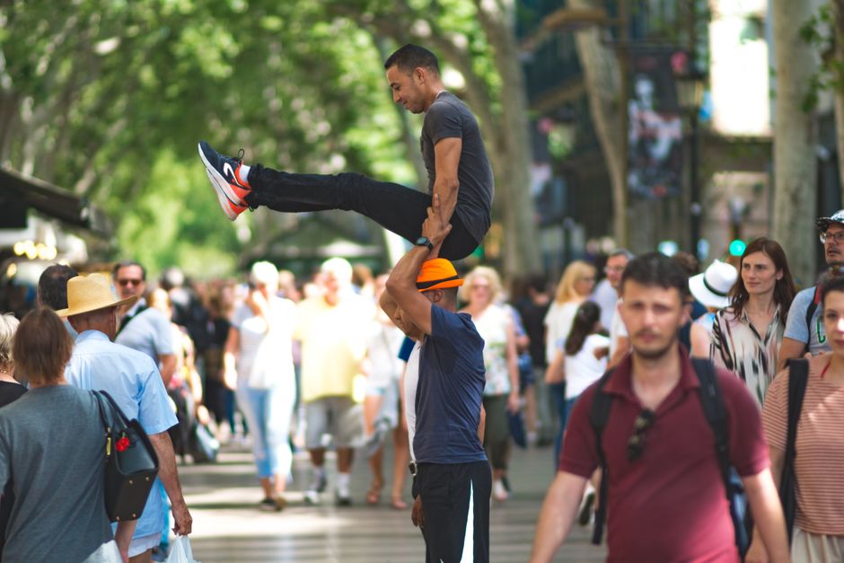 Tourist using a digital map on a phone in a charming street in Barcelona, Spain