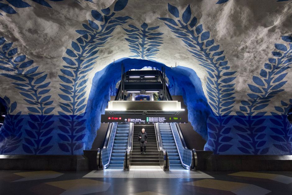 A modern metro station in Stockholm, Sweden, with a train arriving