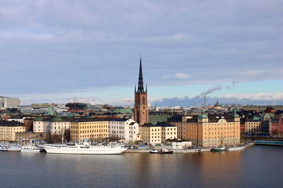 A boat cruising through the Royal Canal in Stockholm, Sweden, with historic buildings along the waterfront.