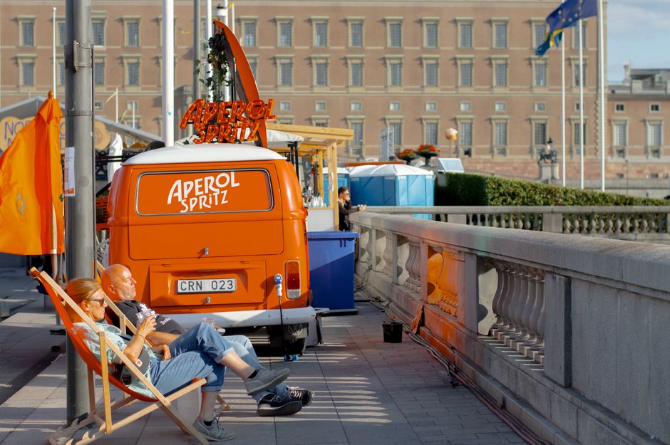 Travelers enjoying a vibrant street scene in Stockholm, Sweden, highlighting the peace of mind travel insurance provides.