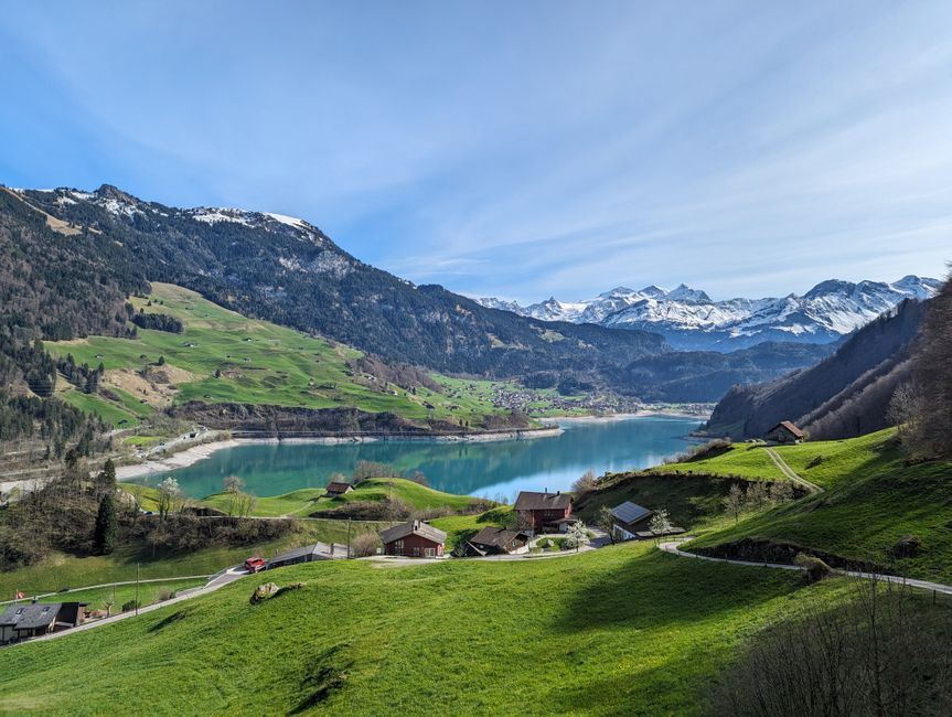 Panoramic view of a train winding through the Swiss Alps, showcasing Switzerland's stunning landscapes.