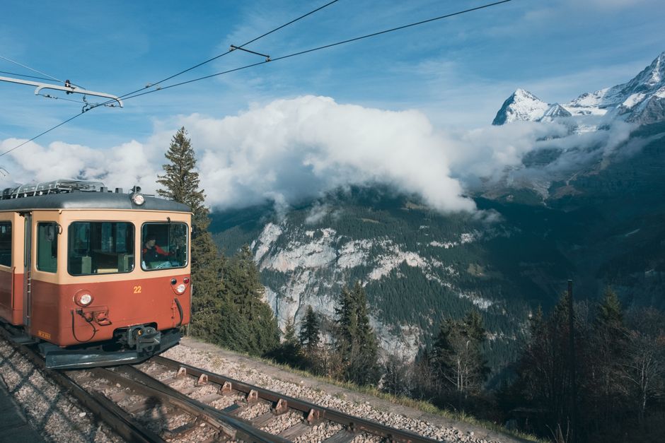 Scenic train journey through the Swiss Alps, representing travel costs in Switzerland.