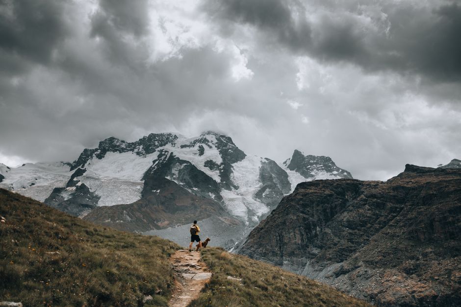 Traveler activating a SIM card on a smartphone with a scenic Swiss mountain backdrop