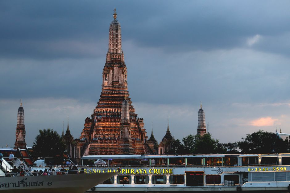 Wat Arun Temple of Dawn glowing at sunset in Bangkok, Thailand