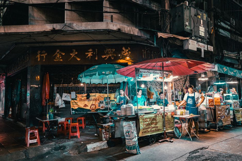 Vibrant street food market in Bangkok, Thailand, with various dishes and local vendors