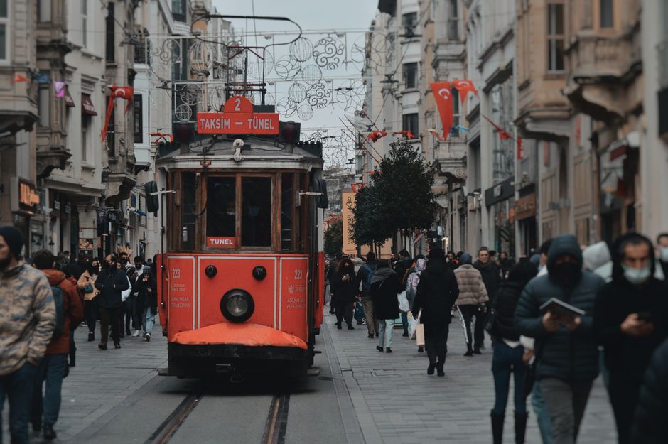 Historic tram passing through a bustling street in Istanbul, Turkey