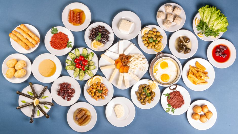 A colorful traditional Turkish breakfast spread with various dishes and tea in Turkey