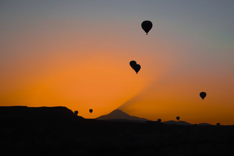 Hot air balloons soaring over Cappadocia's fairy chimneys at sunrise in Turkey