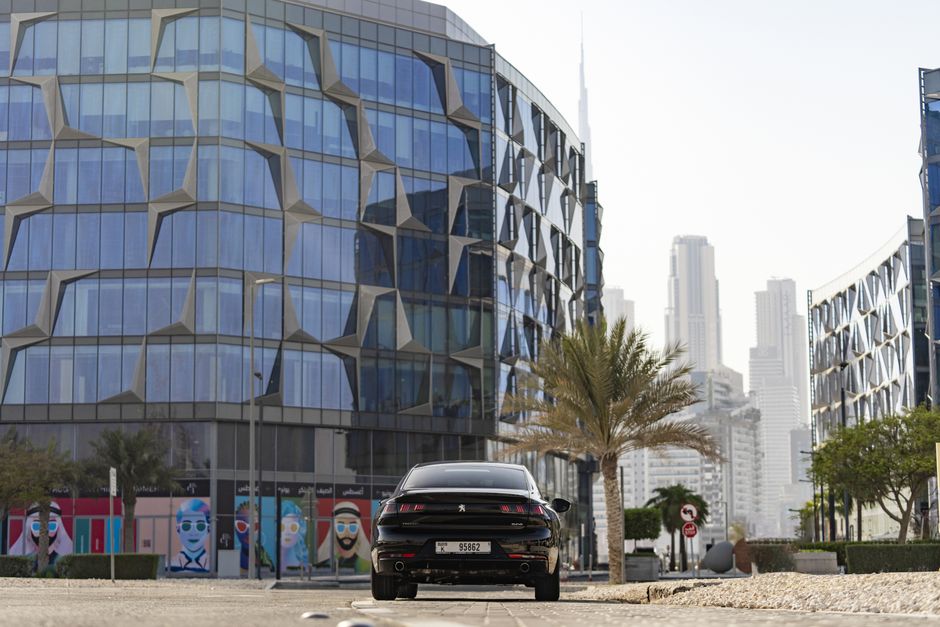 Luxury car parked with Dubai skyline in the background, representing car rental in UAE