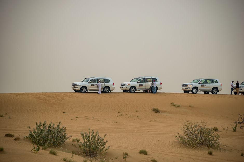 Tourists enjoying a desert safari with dunes in Dubai, UAE