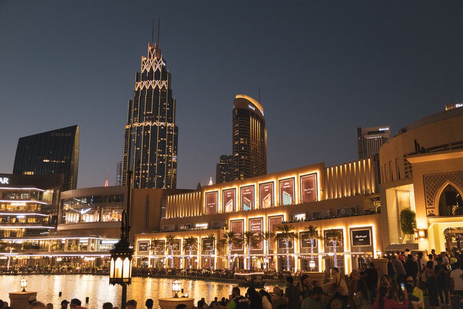 Tourists enjoying shopping and the fountain show at The Dubai Mall, UAE