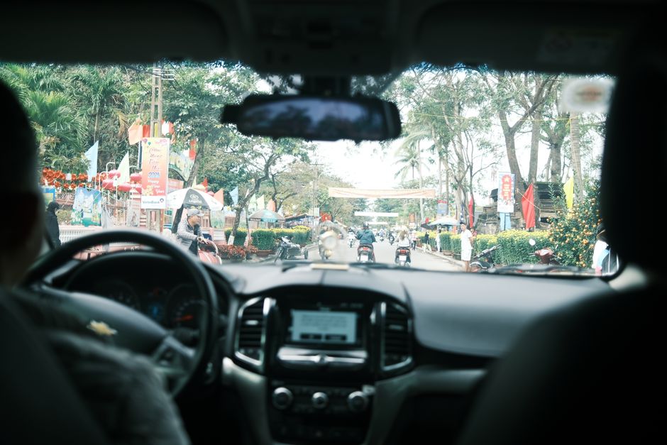 A comfortable private car with a local driver on a scenic road in Vietnam, ready for a smooth journey