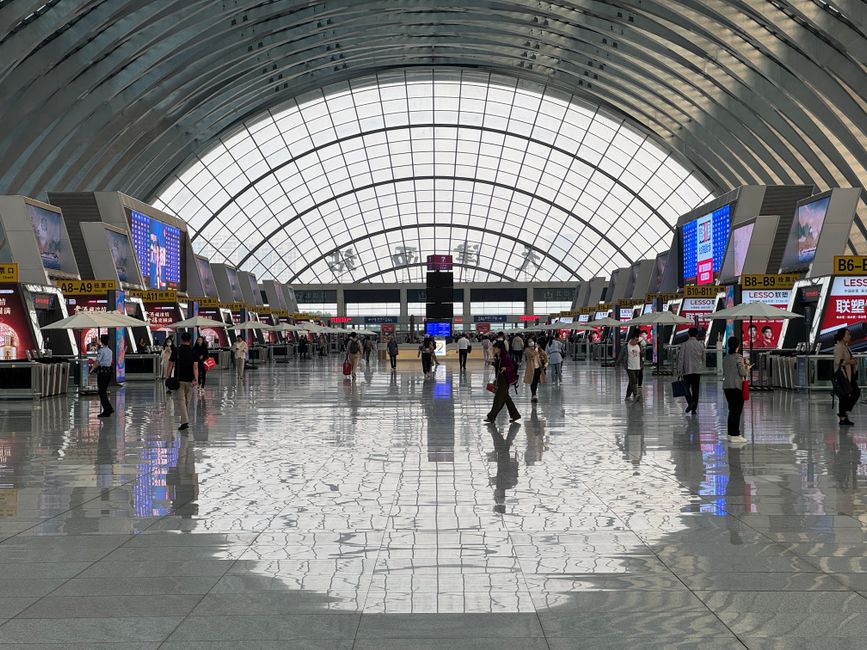Travelers waiting patiently at a modern airport terminal in Hanoi, Vietnam, possibly due to a flight delay