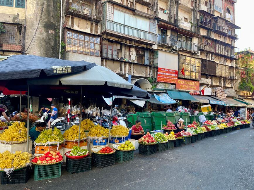 A bustling street food market in Vietnam with various local dishes on display