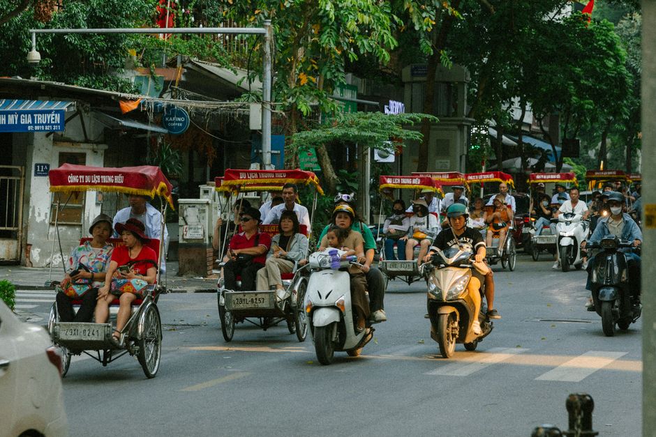 Traveler walking safely through a bustling street in Hanoi, Vietnam, with a secure bag
