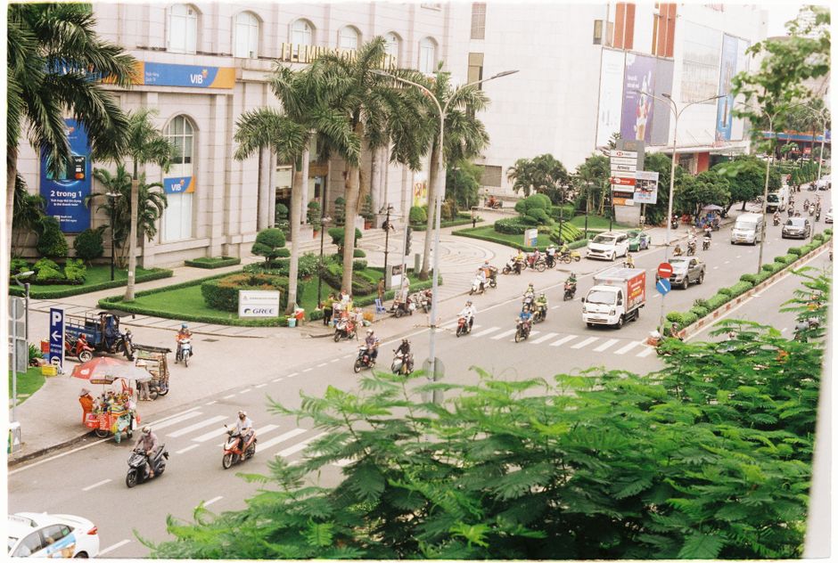 Busy street in Hanoi, Vietnam, filled with motorbikes and local traffic, showcasing the vibrant transport scene