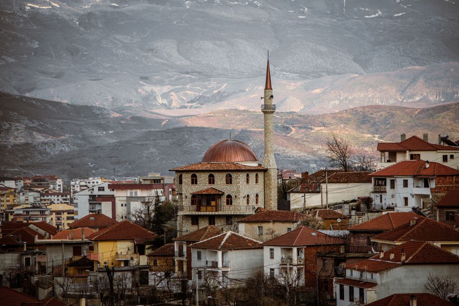 Traditional bujtina guesthouse in Berat, Albania, with Ottoman architecture and lush greenery