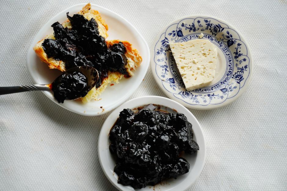 A vibrant spread of traditional Albanian dishes, including byrek and tavë kosi, on a rustic table in Albania.