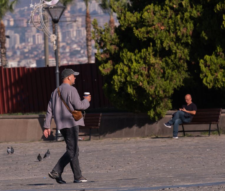 Tourists using mobile phones in a lively street in Tirana, Albania