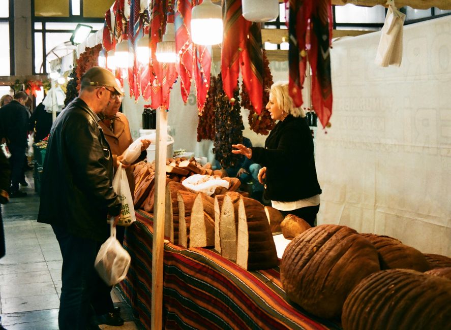 A bustling traditional market scene in Albania, showcasing local produce and crafts