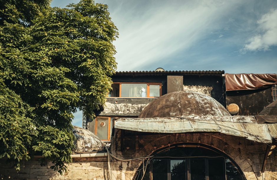 Charming traditional guesthouse in rural Armenia with stone facade and green vines