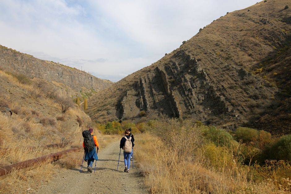 Ancient Garni Temple in Armenia with mountains in the background