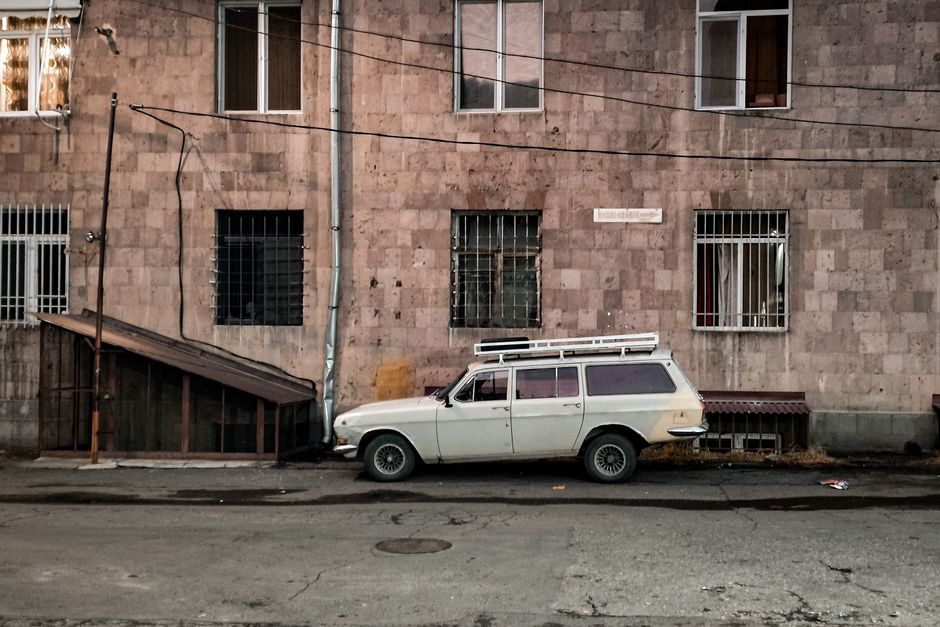 Traveler picking up a rental car in Armenia, ready for a road trip