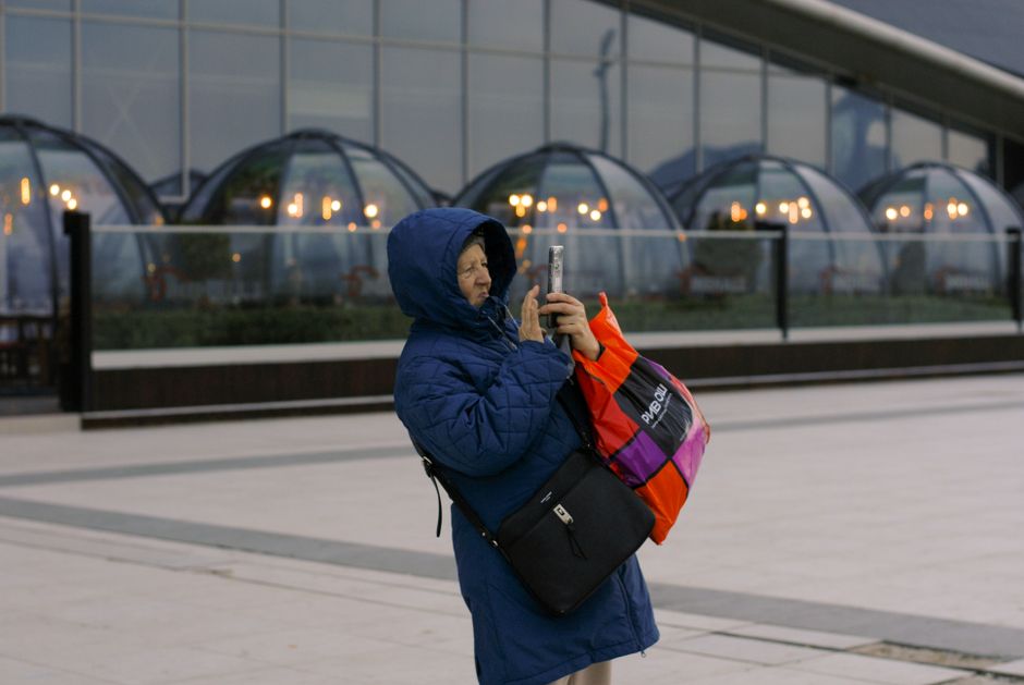 Traveler checking phone in Republic Square, Yerevan, Armenia