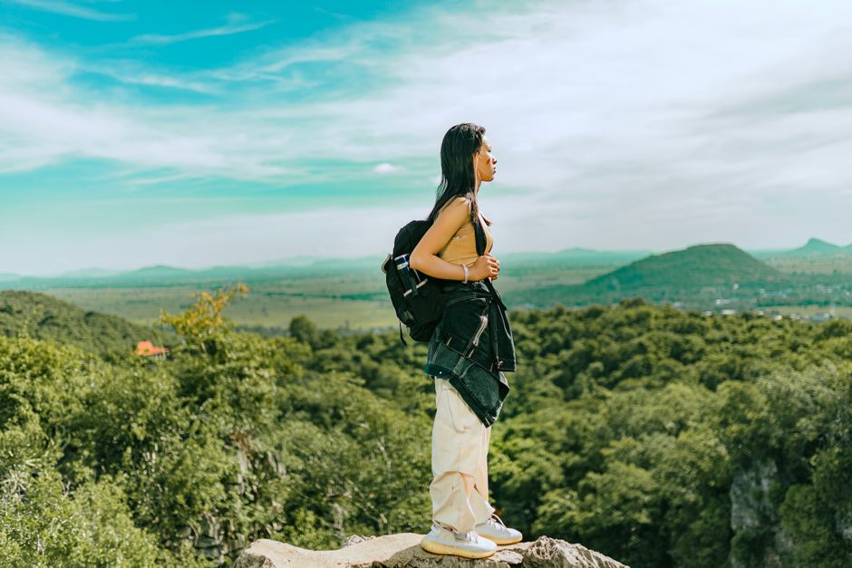 Woman with hiking boots and backpack exploring the scenic mountains of Armenia