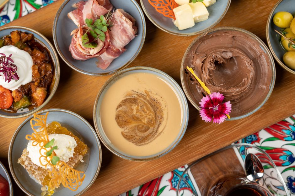 A vibrant spread of traditional Azerbaijani dishes like Plov, Dolma, and Qutab on a table in Baku