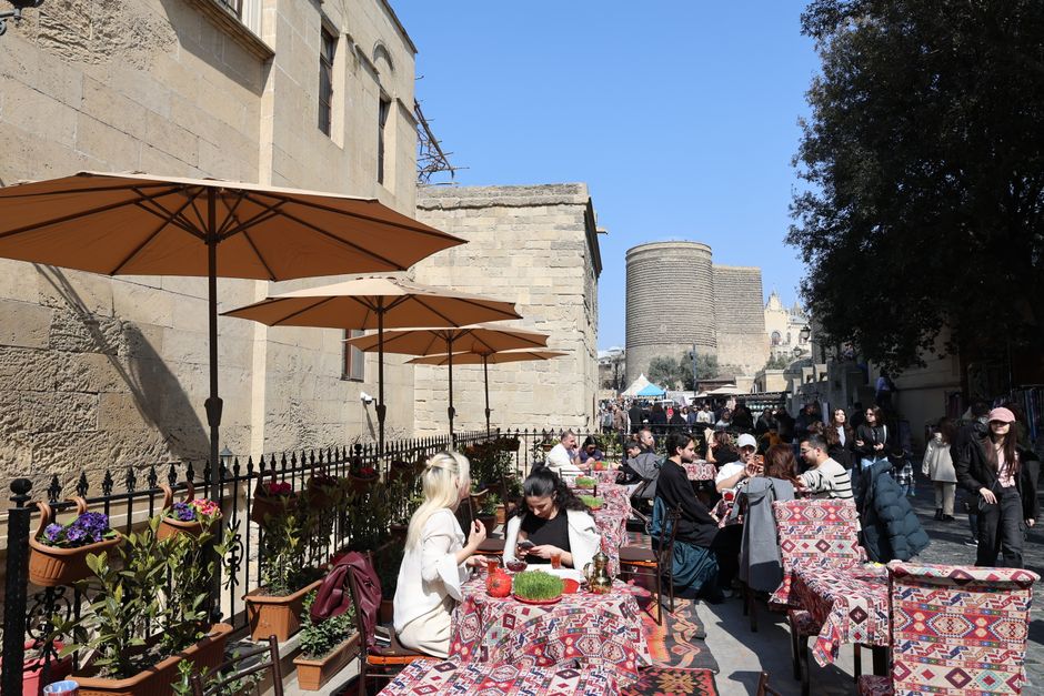 Tourist using a smartphone in Baku Old City, Azerbaijan, connecting to the internet