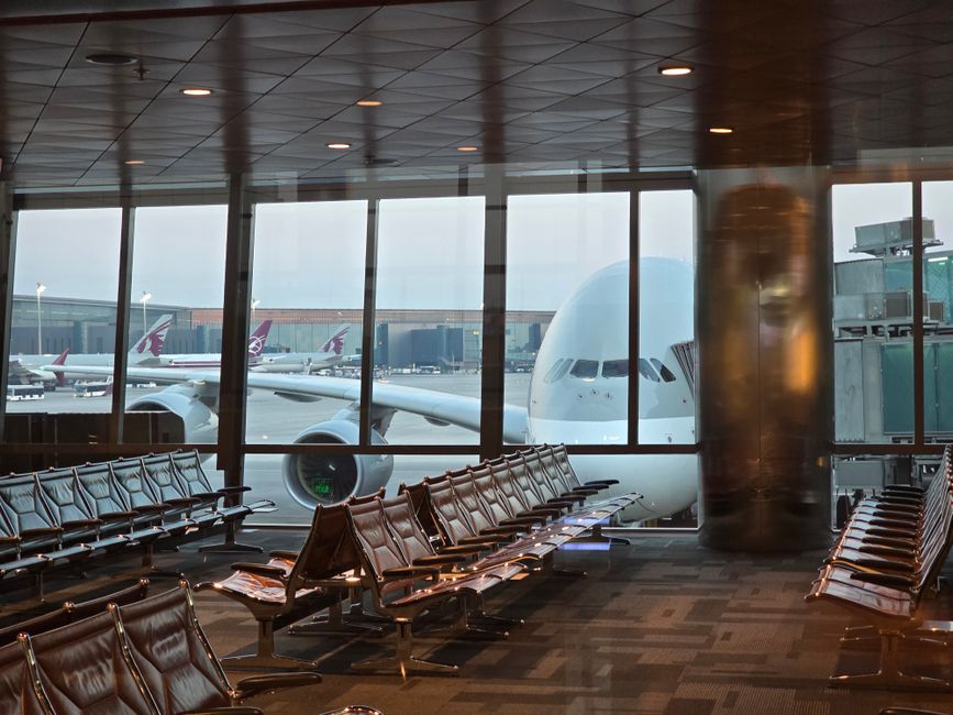 Modern terminal at Bahrain International Airport with planes on the tarmac
