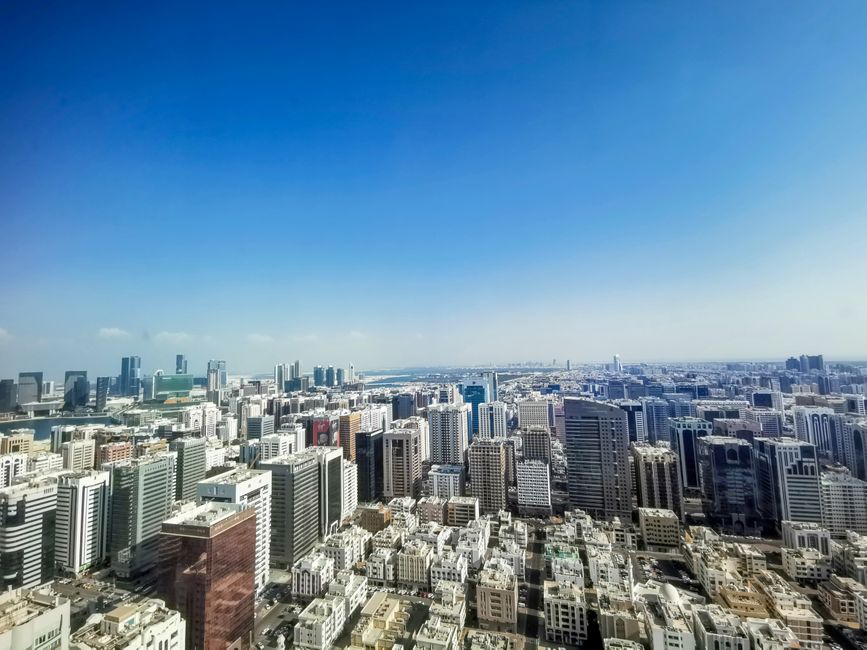 Sunny skyline of Manama, Bahrain, with modern buildings and clear skies.