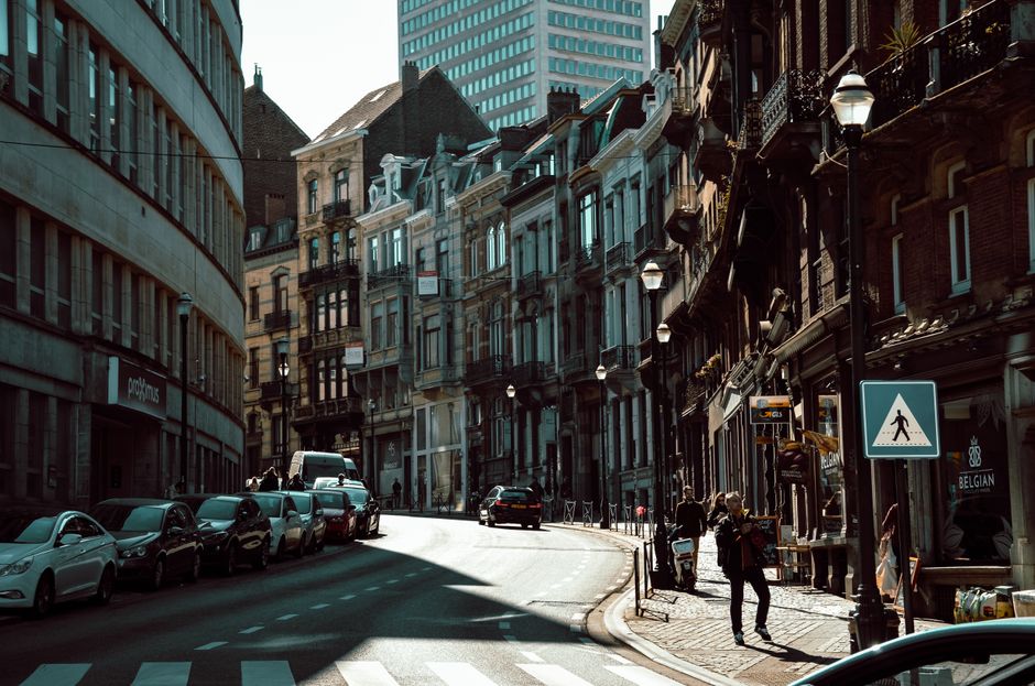 Traveler using a smartphone for navigation in a historic square in Brussels, Belgium