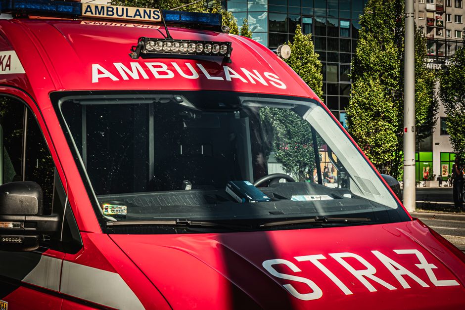 Emergency vehicles, police car, ambulance, and fire truck in a Belgian city street