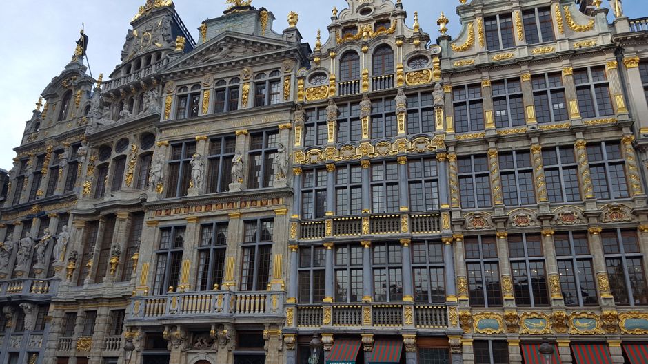 Sunny day at Grand Place in Brussels, Belgium, with historic buildings and blue sky