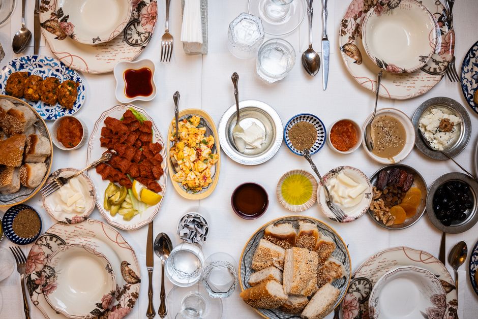 A vibrant spread of traditional Bosnian dishes like ćevapi, burek, and baklava on a wooden table in Bosnia and Herzegovina.
