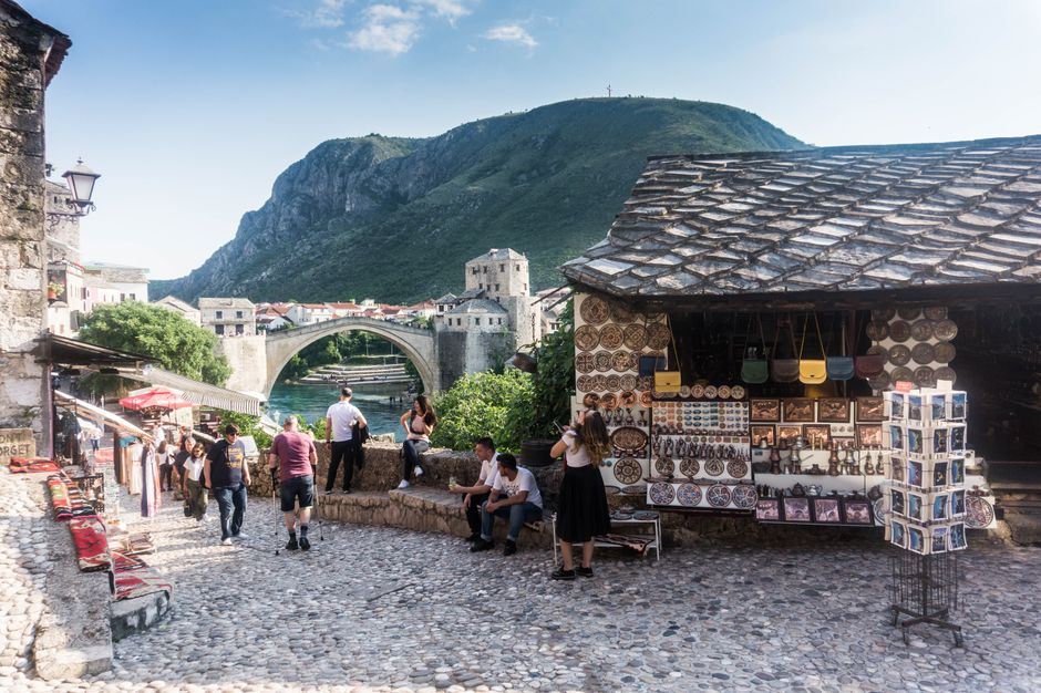 A bustling street scene in Sarajevo, Bosnia and Herzegovina, showing people walking safely