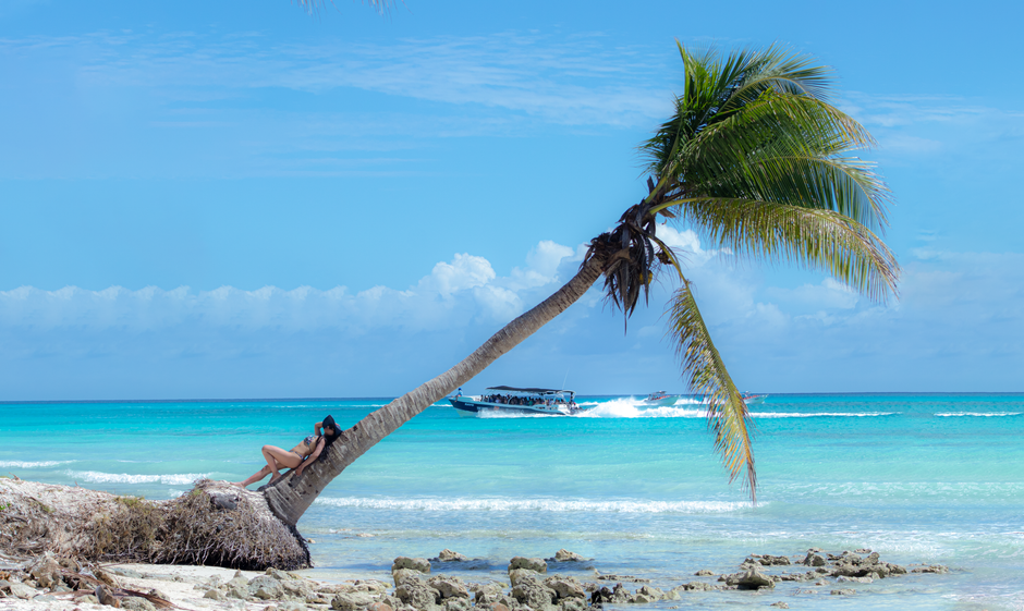 Catamaran sailing towards Saona Island, Dominican Republic, with turquoise waters and palm trees