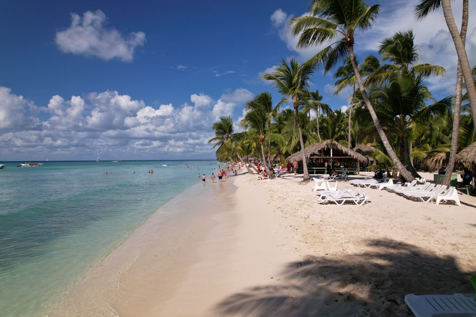 Traveler checking phone on a beautiful beach in the Dominican Republic