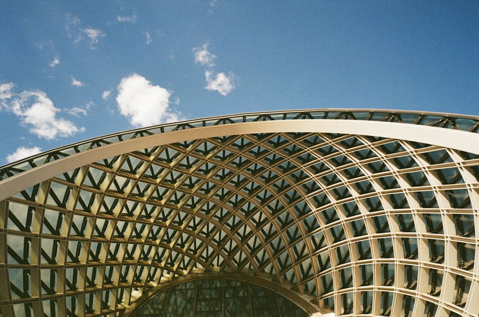 Modern exterior of Tbilisi Shota Rustaveli International Airport in Georgia with arriving passengers