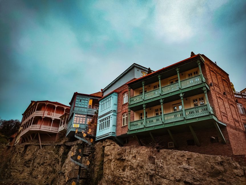 Vibrant street scene in Tbilisi Old Town, Georgia, with traditional balconies and people walking