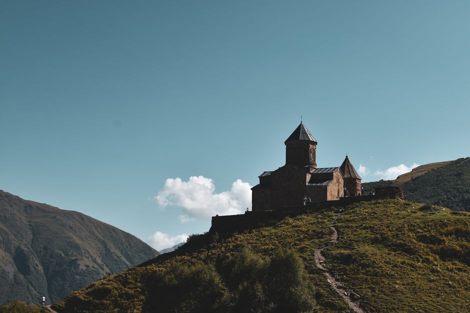 Gergeti Trinity Church nestled in the stunning mountains of Stepantsminda, Georgia, a popular day trip destination