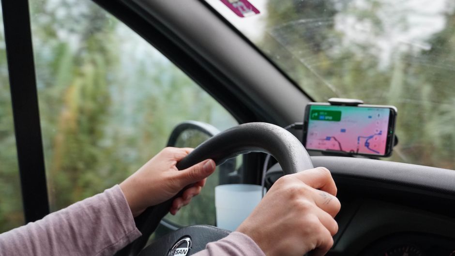 Traveler using a smartphone with a map app to navigate in the mountains of Georgia