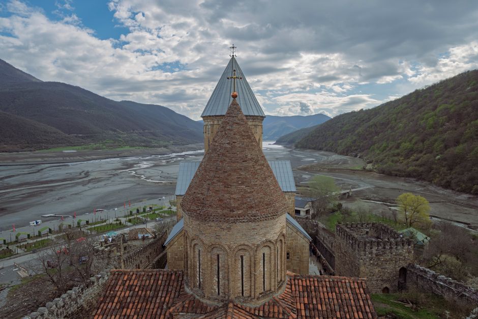Stunning panoramic view of Georgia's diverse landscapes, showcasing mountains, valleys, and historical architecture, representing its regions.