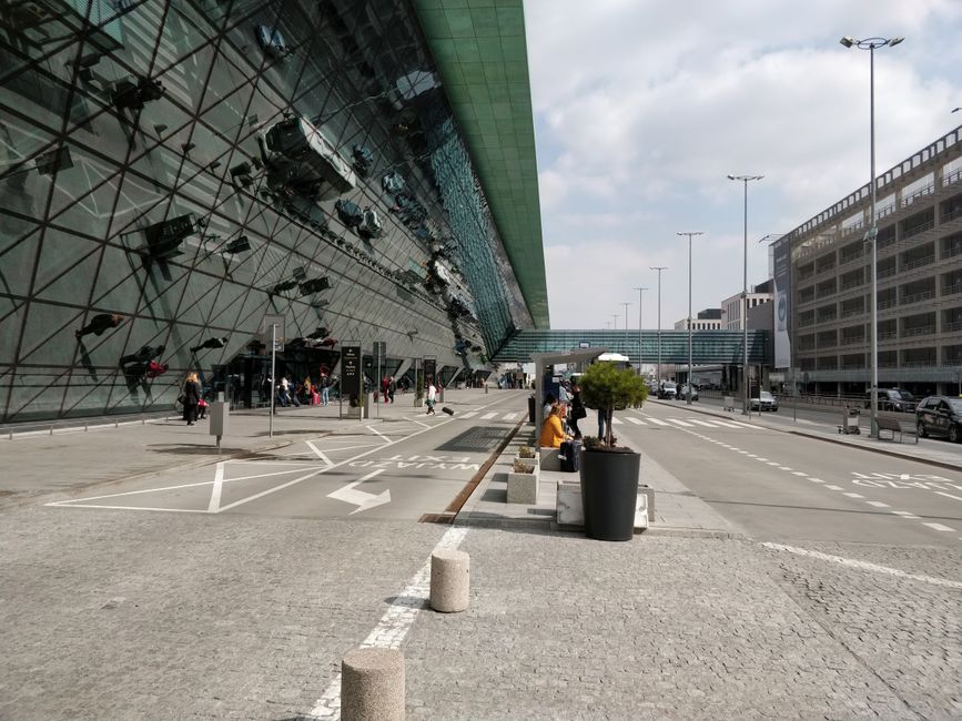 Modern exterior of Tbilisi International Airport in Georgia with mountains in the background